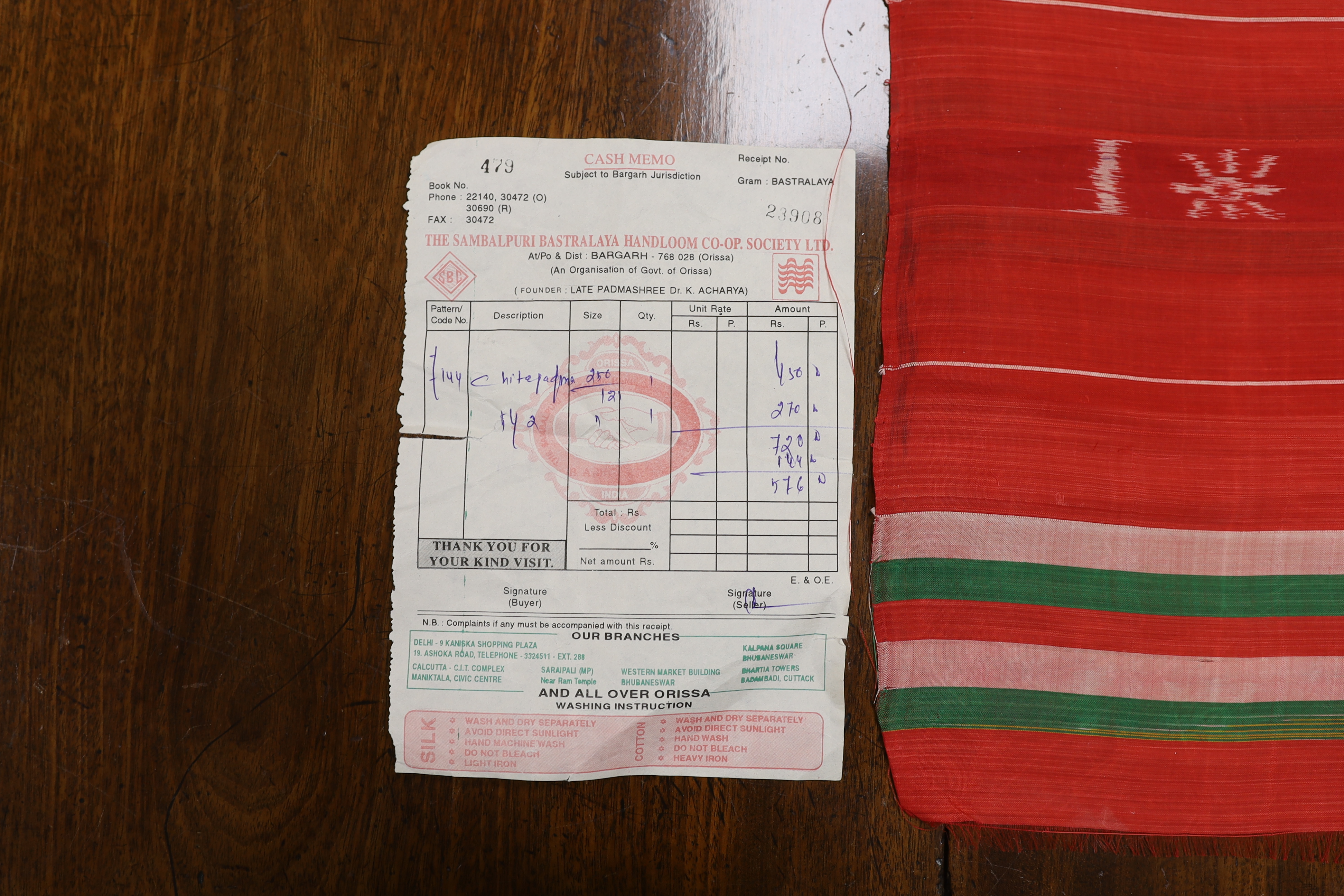 An Indian silk woven cloth, possibly a temple cloth, from Orissa, printed on the warp, with original receipt and paper bag